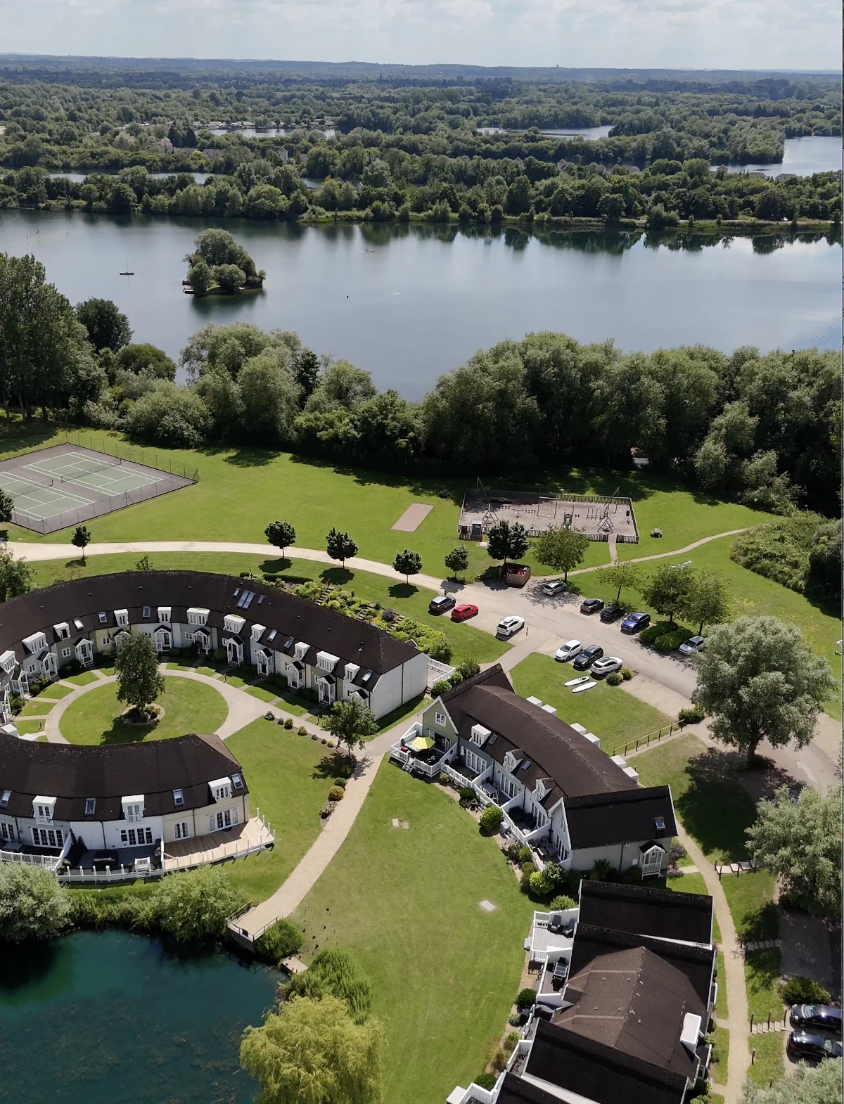 The tennis courts and playground together beside Isis Lake