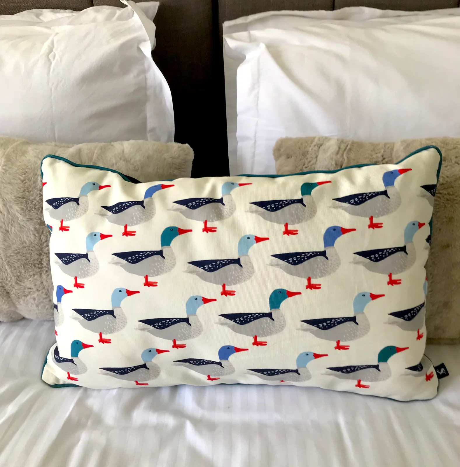A duck cushion styling detail in Bedroom 3 at Grey Heron Lodge