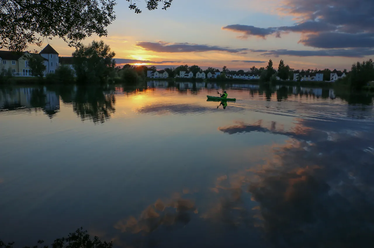 A kayaker on the lake at sunset