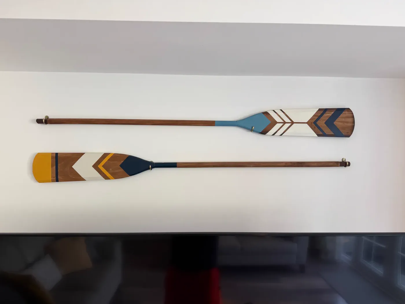 Decorative paddles displayed at Green Woodpecker Lodge