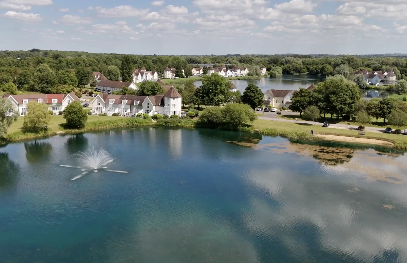 An aerial view of Cotswold Lake Lodges surrounded by the water park's lakes