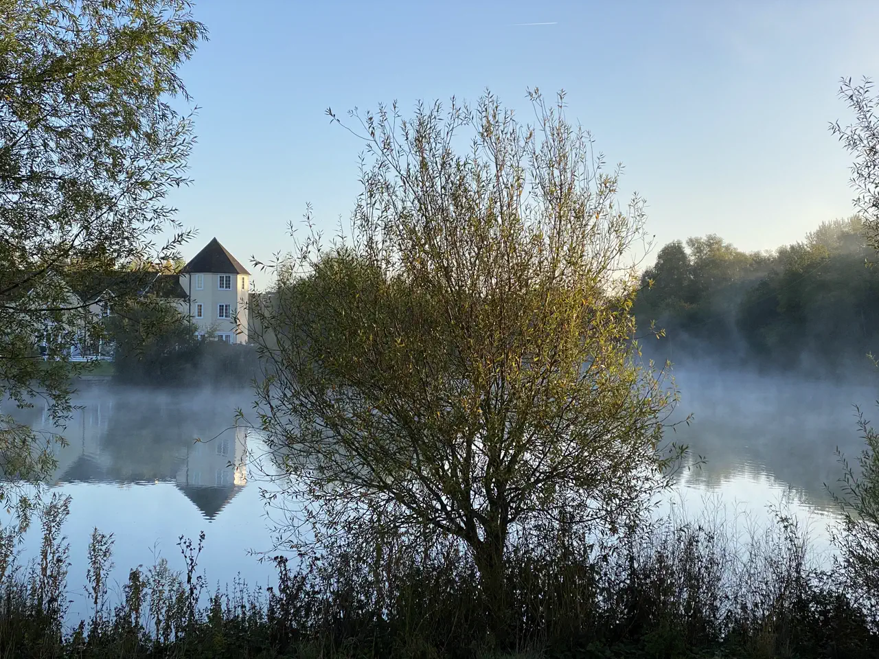 Mist rising off Windrush Lake on an autumn morning